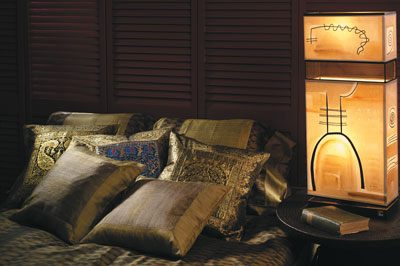 
A handwoven, hand-dyed silk ikat duvet cover and ­pillows from Laos (womankind.com) and silk brocade ­cushion covers made in Varanasi, India, (Novica.com) adorn this romantic bedroom. The lamp, hand-painted by Brazilian artist Ana Maia, is available from Worldwide Import/Export (wwiec.com).
